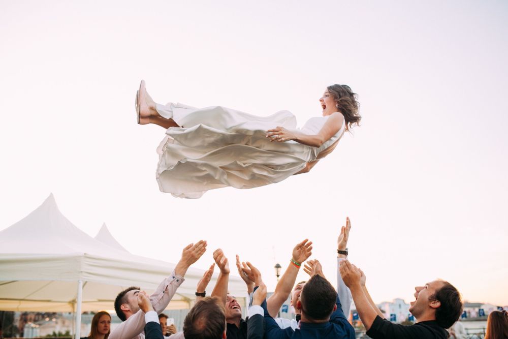 A bride tossed up in the air